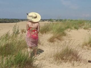 Nude scorching cougar on a nude beach.