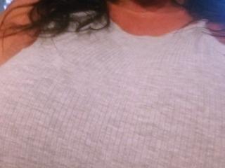 Busty curly brunette with big boobs fucks on couch